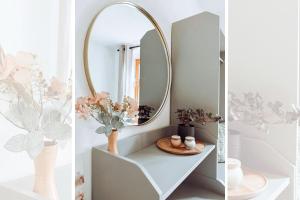 a bathroom with a mirror and a shelf with flowers at Niedere Burgstraße - im Herzen der Altstadt in Pirna