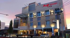 a rendering of a hotel with chairs in front of it at Mega Permata Hotel in Padangsidimpuan