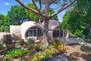 a house with a tree in front of it at Sunshine Coast Hinterland Igloo Retreat Romantic & Private in Flaxton