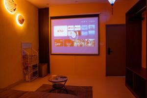 a projection screen on a wall in a room at 1993 Homestay G&C Quảng Trị in Quang Tri