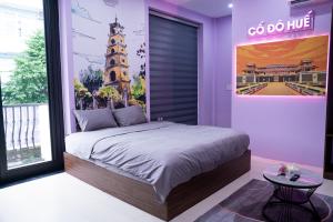 a bedroom with a large bed and a large clock tower at 1993 Homestay G&C Quảng Trị in Quang Tri