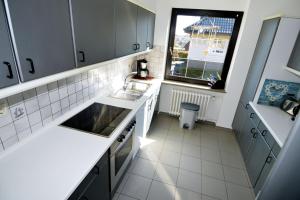 a small kitchen with a sink and a window at Breslauer Haus in Heiligenhafen