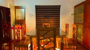 a dining room with a table and some chairs at Karmalhills Homestay in Tindummal