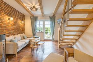 a living room with a couch and a brick wall at Ferienwohnung Ina Meta in Reppenhagen