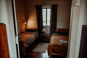 a small bedroom with two beds and a window at Two Brothers' Cabin in Deeside