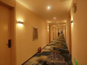 ein Flur mit einem langen Flur mit einem langen Gang in der Unterkunft Shell Hotel Chuzhou Economic Development Zone Internation Shangcheng in Chuzhou