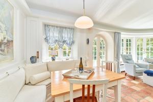 a living room with a couch and a table at Inselhüs Kampen in Kampen +37 photos