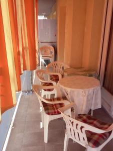 a group of tables and chairs in a room at Apartamentos Montserrat in Blanes