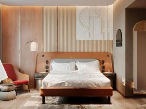 a bedroom with a bed and a red chair at Mövenpick Yerevan in Yerevan +54 photos