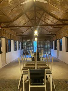 a dining room with a table and chairs in a building at Hill Myna Vacation House in Nagpoyopoyo Island