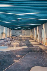a swimming pool with a fountain in a building at Suvretta House in St. Moritz