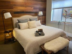 a bedroom with a large bed with a wooden wall at Allview Escape Blackheath in Blackheath