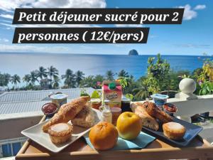 a table with a plate of food on a table at Pause tropicale in Le Diamant