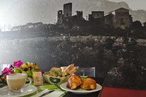 a table with a plate of croissants and a cup of coffee at B&B Maison Civico 13 in Ausonia