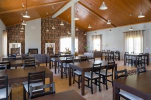 a restaurant with tables and chairs in a room at Casas de São José in Rio Maior