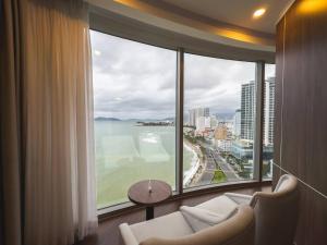 a room with a large window with a view of the ocean at Nha Trang Horizon Hotel in Nha Trang +108 photos