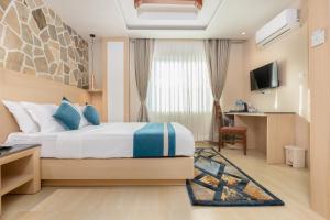 a hotel room with a bed and a desk at Tulsi Kathmandu Hotel in Kathmandu