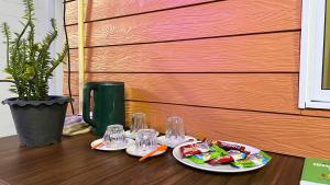 a table with two plates of food and glasses on it at Similan Mondo Resort & Camping in Phangnga