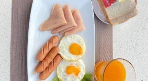 a plate of breakfast food with eggs sausage and bread at Phala Shore Resort in Ban Phala