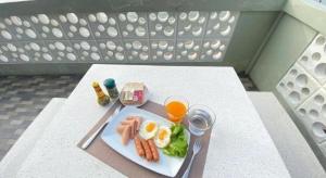 a plate of food and a glass of orange juice at Phala Shore Resort in Ban Phala +97 photos