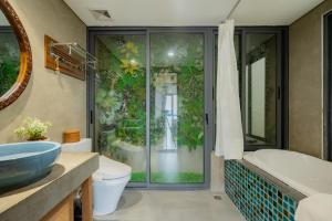 a bathroom with a shower and a toilet and a sink at XÔI Sakamoto 2 Suites Kim Ma in Hanoi +193 photos