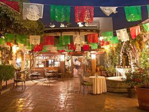 a room with tables and chairs and colorful flags at Quinta Don Jose Boutique Hotel in Guadalajara