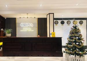 a christmas tree in the front of a store at Orova Hotel in Ấp Phú Thọ