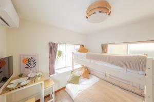 a bedroom with a bunk bed and a desk at Hotel Emile102 in Tachikawa