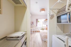 two views of a kitchen and a living room at Hotel Emile102 in Tachikawa