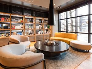 a lobby with chairs and a coffee table at Comfort Hotel ERA Sapporo North in Sapporo