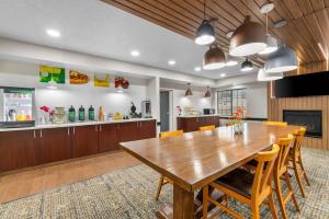 una grande sala da pranzo con tavolo e sedie in legno di Quality Inn Brewerton - Syracuse Oneida Lake Area a Brewerton