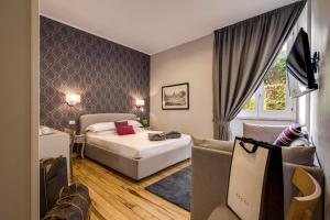 a hotel room with a bed and a couch at The Club Navona in Rome