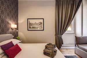 a hotel room with a bed and a couch at The Club Navona in Rome