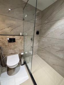 a bathroom with a shower and a toilet at Hotel Raj Hari Palace in Jodhpur