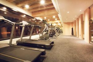 a gym with a treadmill and bikes in it at Inn by the Village in Taitung City