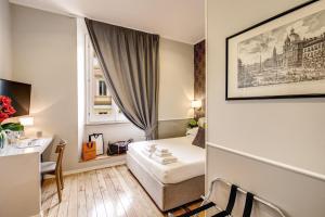 a small hotel room with a bed and a desk at The Club Navona in Rome