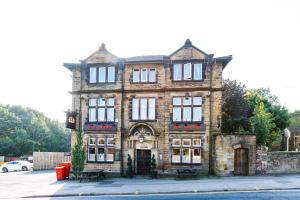 a large brick building on the corner of a street at The Old Crown Inn in Sheffield