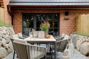 a table and chairs on a patio at Haus Möhre in Tinnum +18 photos