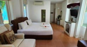 a living room with a bed and a couch at Ozono Resort in Thung Faek