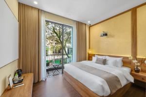 een slaapkamer met een groot bed en een groot raam bij Lucas Boutique Home Hue in Thôn Trường Giang