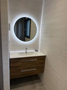 a bathroom with a sink and a mirror at The Eagle's Nest - cosy chalet for two in Jarjayes