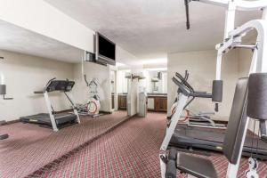 a gym with two treadmills and two exercise bikes at Ramada Limited Norfolk in Greenwich