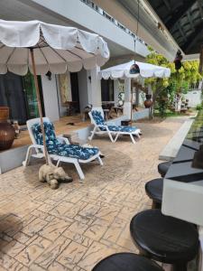 two chairs and an umbrella on a patio at Ban thale in Koh Samui