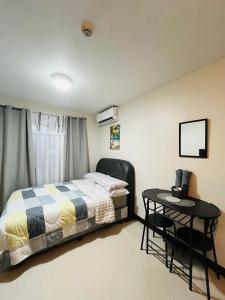 a bedroom with a bed and a table at Richloves Haven in Suba +4 photos