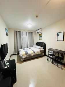 a bedroom with a bed and a table at Richloves Haven in Suba