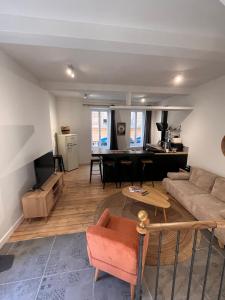 a living room with a couch and a table at Charmant duplex in Moulins