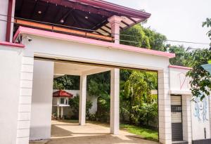 a white building with an open door at Divas Hostels in Ahangama