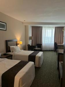 Postel nebo postele na pokoji v ubytování Hotel Felda Residence Kuala Terengganu