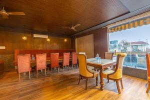 a dining room with a table and chairs at The Global Hotel by Platinum I 100m Medanta Hospital I Sector-38 I Gurgaon in Gurgaon