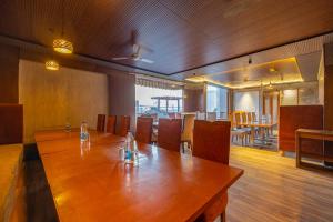 a conference room with a wooden table and chairs at The Global Hotel by Platinum I 100m Medanta Hospital I Sector-38 I Gurgaon in Gurgaon